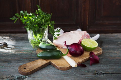 Raw chicken, lemongrass, red onion, lime, parsley, jalapenos stock photo