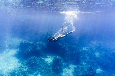 Woman swimming underwater in sea - CAVF28409