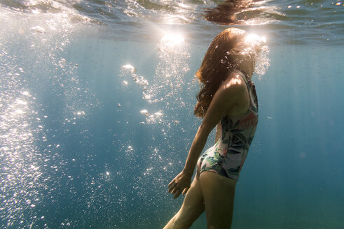 Young woman swimming in sea - CAVF28416