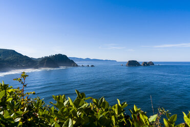 Scenic view of cannon beach against blue sky - CAVF28443