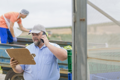 Farm worker talking on the phone stock photo