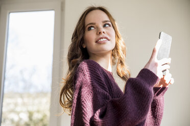 Portrait of teenage girl with cell phone - FMKF04988