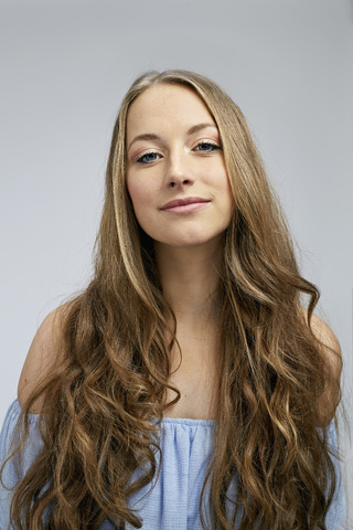 Portrait of smiling young woman with long hair stock photo