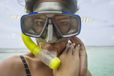 Portrait of woman with snorkel and diving goggles stock photo