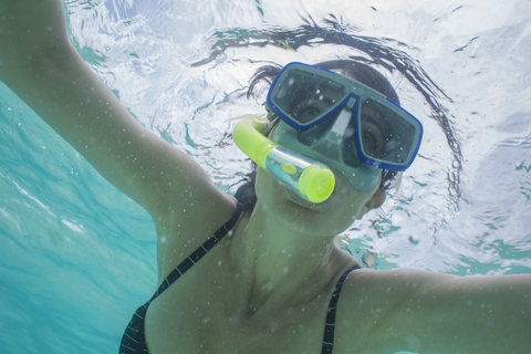 Portrait of woman snorkeling under water stock photo