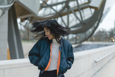 France, Paris, smiling young woman tossing her hair stock photo