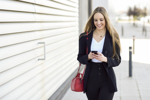 Portrait of content businesswoman using cell phone stock photo