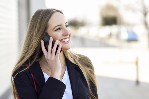 Portrait of happy businesswoman on the phone stock photo