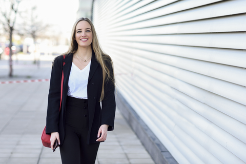 Portrait of relaxed businesswoman outdoors stock photo