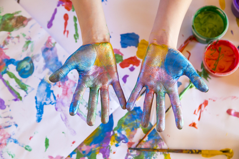 Girl playing with finger paint stock photo