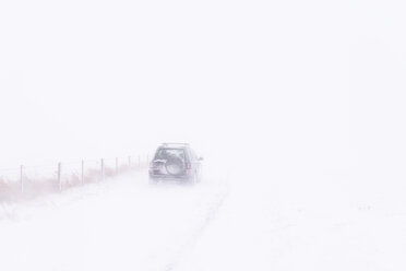UK, Scotland, East Lothian, North Berwick, snowdrifts, off road vehicle during winter storm - SMAF00985