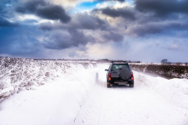 United Kingdom, Scotland, East Lothian, North Berwick, snowdrifts, off road vehicle during winter storm - SMAF00993