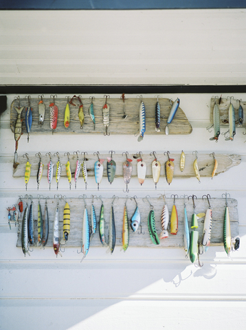 Collection of fishing tackles on wall stock photo