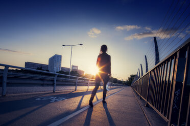 Woman walking down bridge - FOLF00672