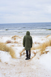 Rear view of mid adult man standing on beach in winter - FOLF00761