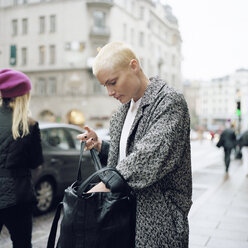 Mid adult woman rummaging in purse - FOLF00796