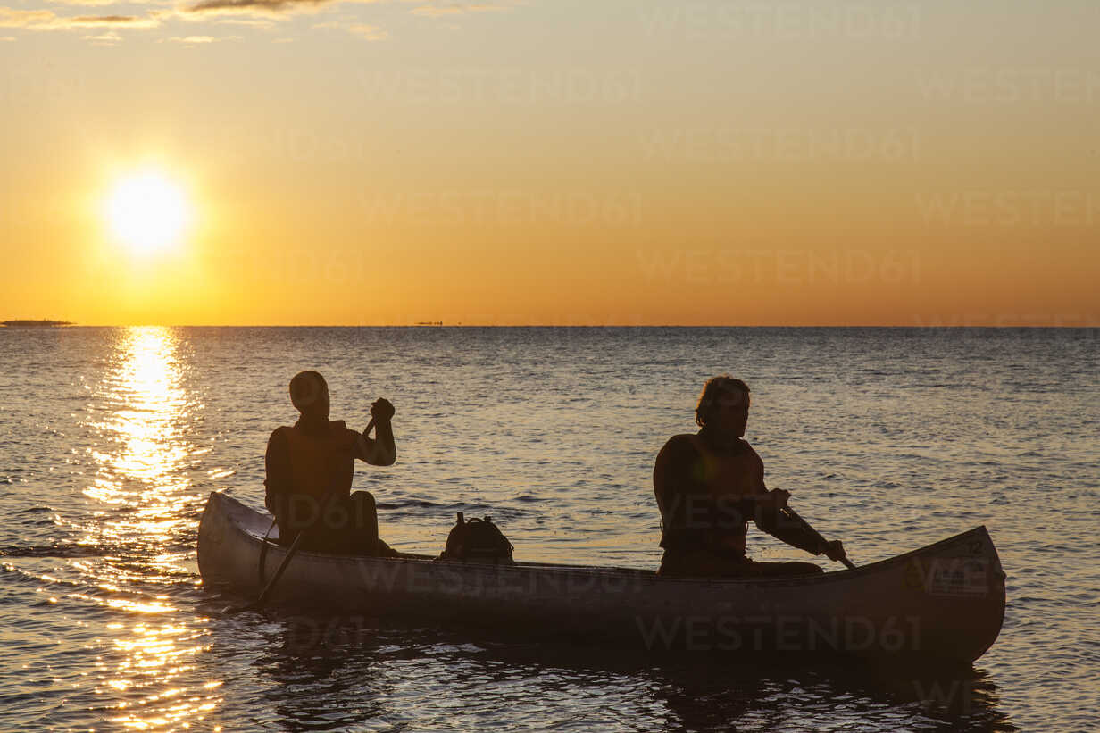Two Men Fishing in Canoe by CSA Images