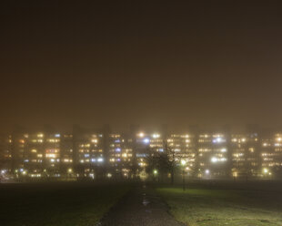 Illuminated residential buildings in fog - FOLF01043