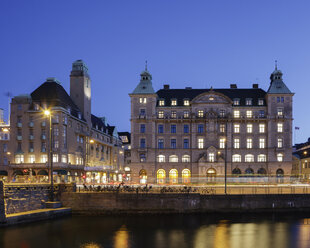 Illuminated buildings with river in foreground at dusk - FOLF01061