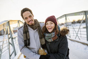 Young couple on footbridge in winter - FOLF01203