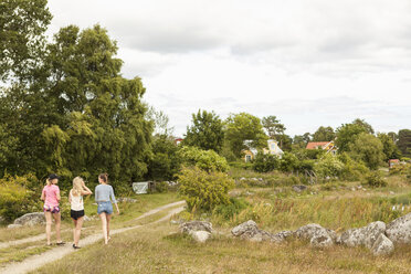 Teenage girls walking on footpath - FOLF01212