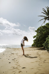 Side view of carefree woman standing on beach - CAVF28774