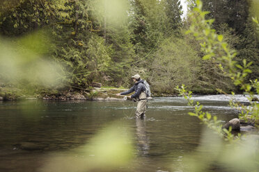 Side view of man fishing at river - CAVF28829