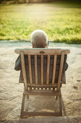 Rear view of senior man sitting on chair - FOLF01329