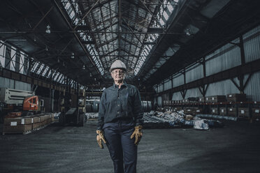 Portrait of confident female worker standing in metal industry - CAVF28974