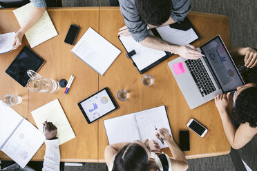 High angle view of business people analyzing data in meeting at board room - CAVF29011