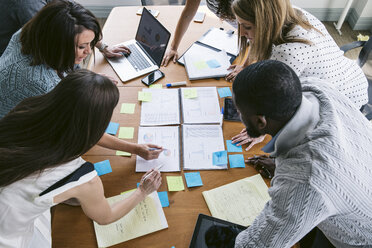 High angle view of business people brainstorming in board room - CAVF29046