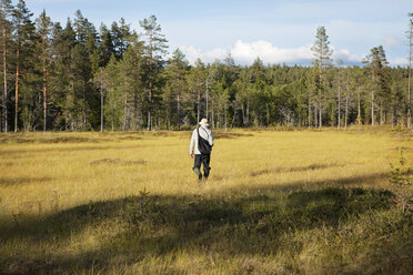 Man walking in field - FOLF01383