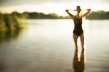 Defocused image of swimmer standing in lake - CAVF29139