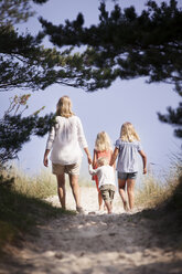 Mother with son and daughters walking along footpath - FOLF01478
