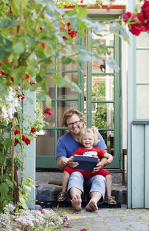 Portrait of daughter with father holding tablet pc - FOLF01485