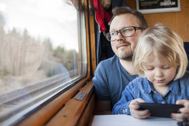 Father and daughter traveling by train - FOLF01525