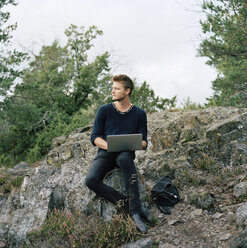 Man using laptop in forest - FOLF01579