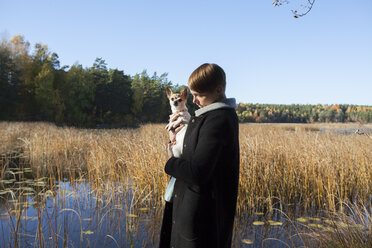 Woman with dog in wetland - FOLF01588