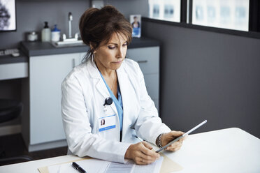 Female doctor using tablet computer in clinic - CAVF29292