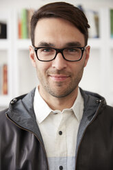 Close-up portrait of confident businessman smiling at home - CAVF29385