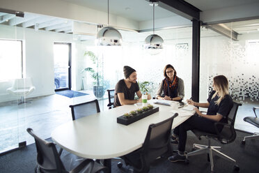 Business people discussing during meeting in creative office - CAVF29442