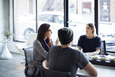 Serious business people discussing during meeting in office - CAVF29445