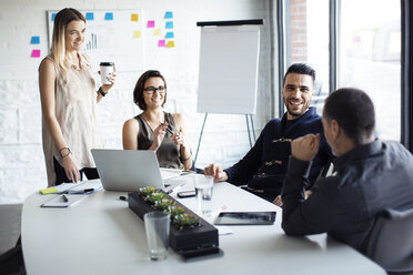 Happy business people discussing at creative office - CAVF29478