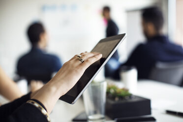 Close-up of businesswoman using digital tablet - CAVF29486