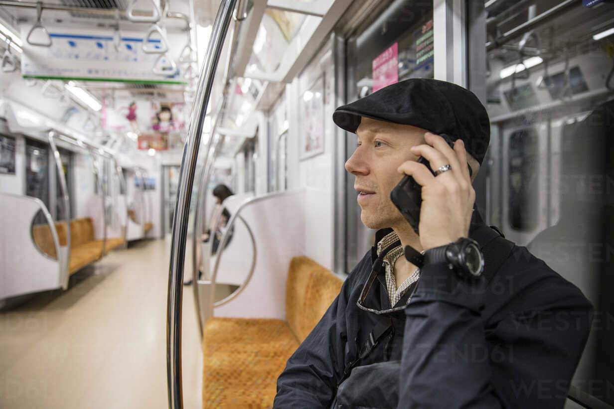 Man talking on phone in subway stock photo