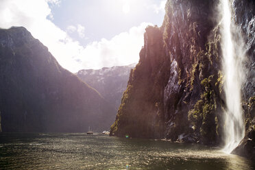 Scenic view of waterfall over mountain by river - CAVF29616