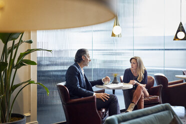 Business people talking while sitting in cafeteria at creative office - CAVF29684