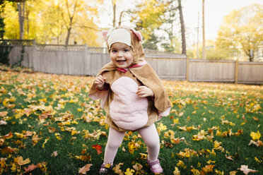 Portrait of happy baby girl wearing bird costume at park - CAVF29861