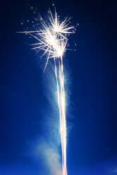 Low angle view of firework display against blue sky - CAVF30018