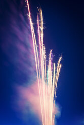 Low angle view of firework display against sky at night - CAVF30019